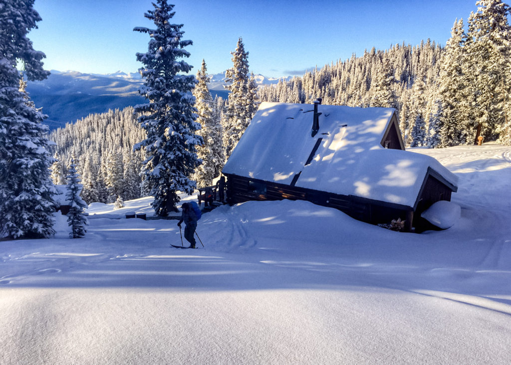 On day two of the 2018 Benedict100, clients rally out of Margy's Hut on a subzero January morning.