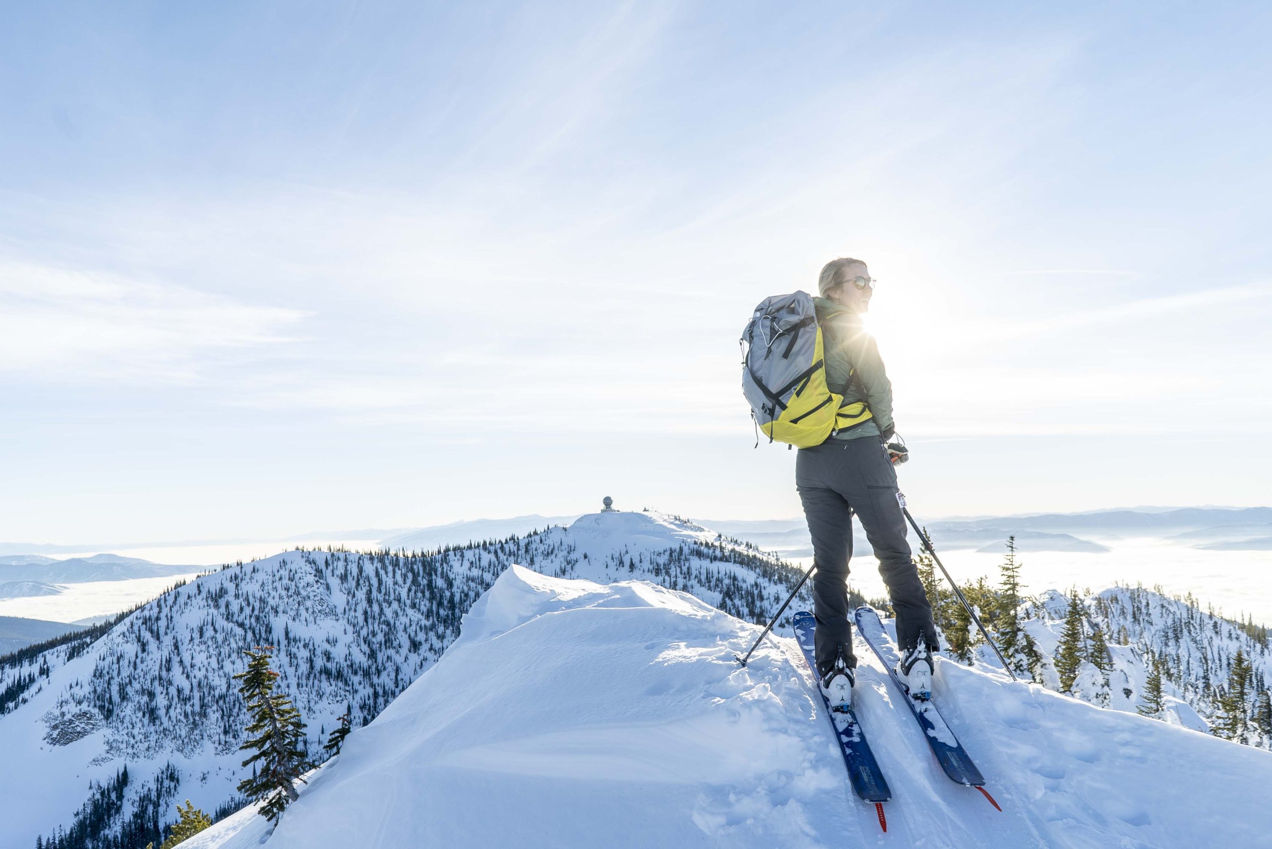 Emily Sullivan enjoying a sunny summit- Women's backcountry skis