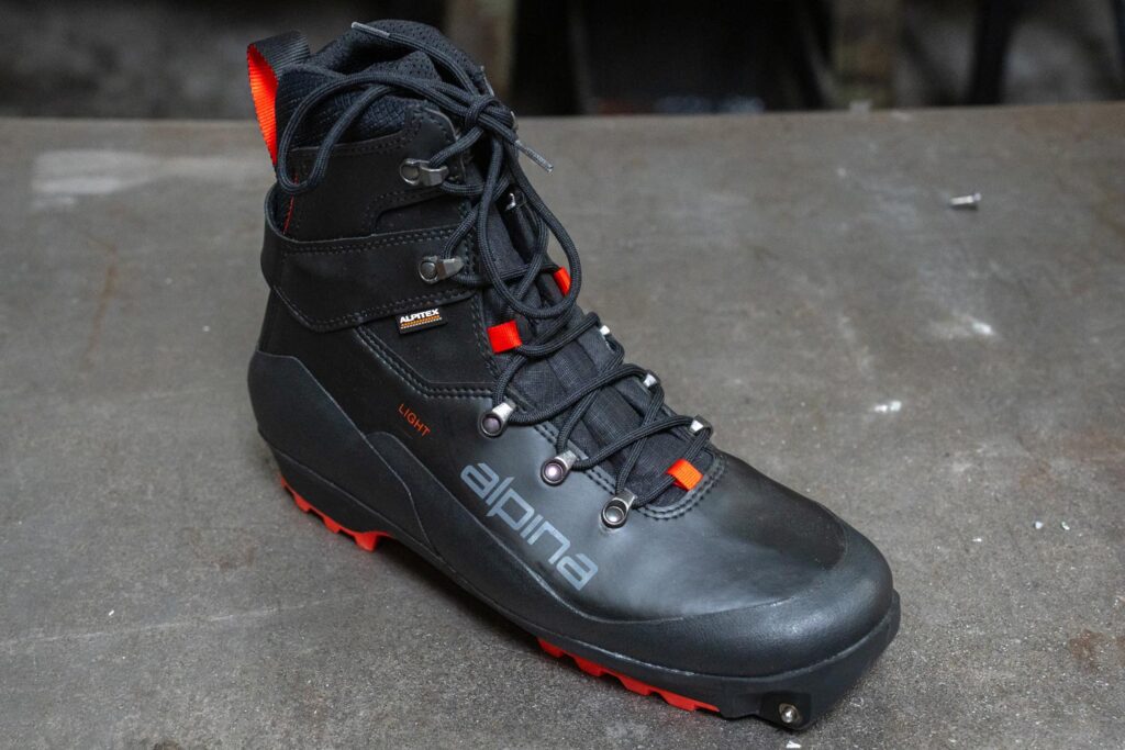 Alpina Pioneer Light XP boot showing its synthetic upper, lacing system, and Xplore-compatible sole.