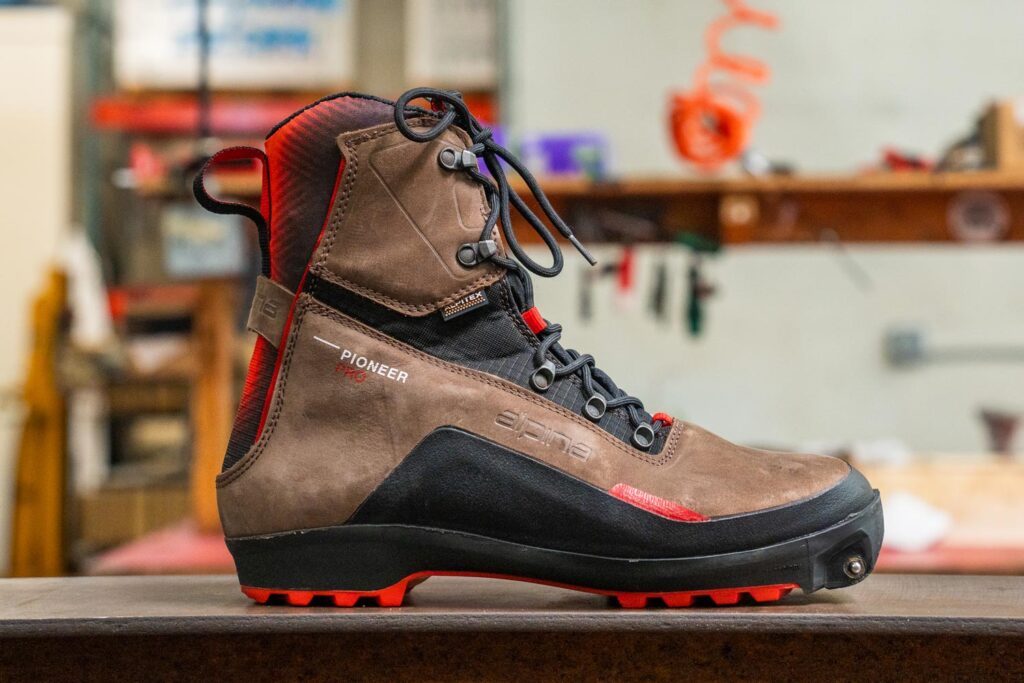 Alpina Pioneer Pro XP boot showing its leather upper, lacing system, and Xplore-compatible sole.
