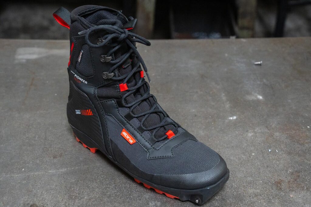 Alpina Pioneer Tech XP boot showing its synthetic upper, reinforced cuff, and Xplore-compatible sole.