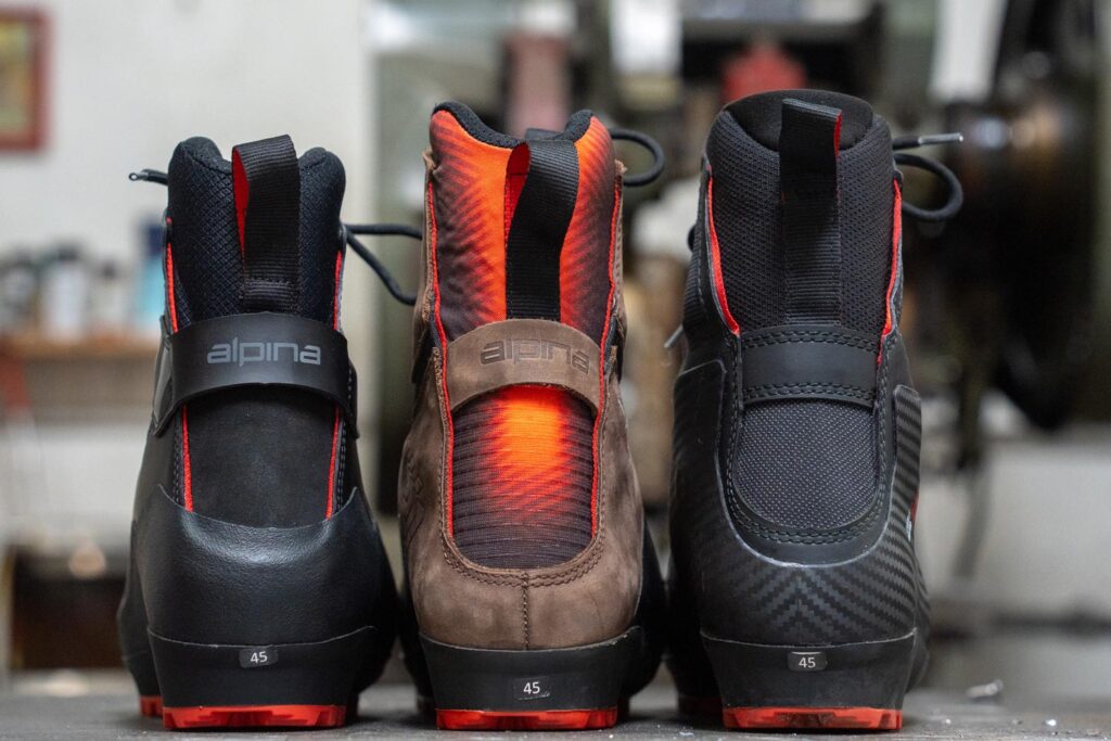 Rear view of Alpina Pioneer Light, Pro, and Tech XP boots showing differences in cuff height and construction.