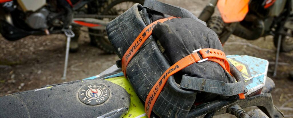 Voile Straps securing extra gear to a motorcycle fender.