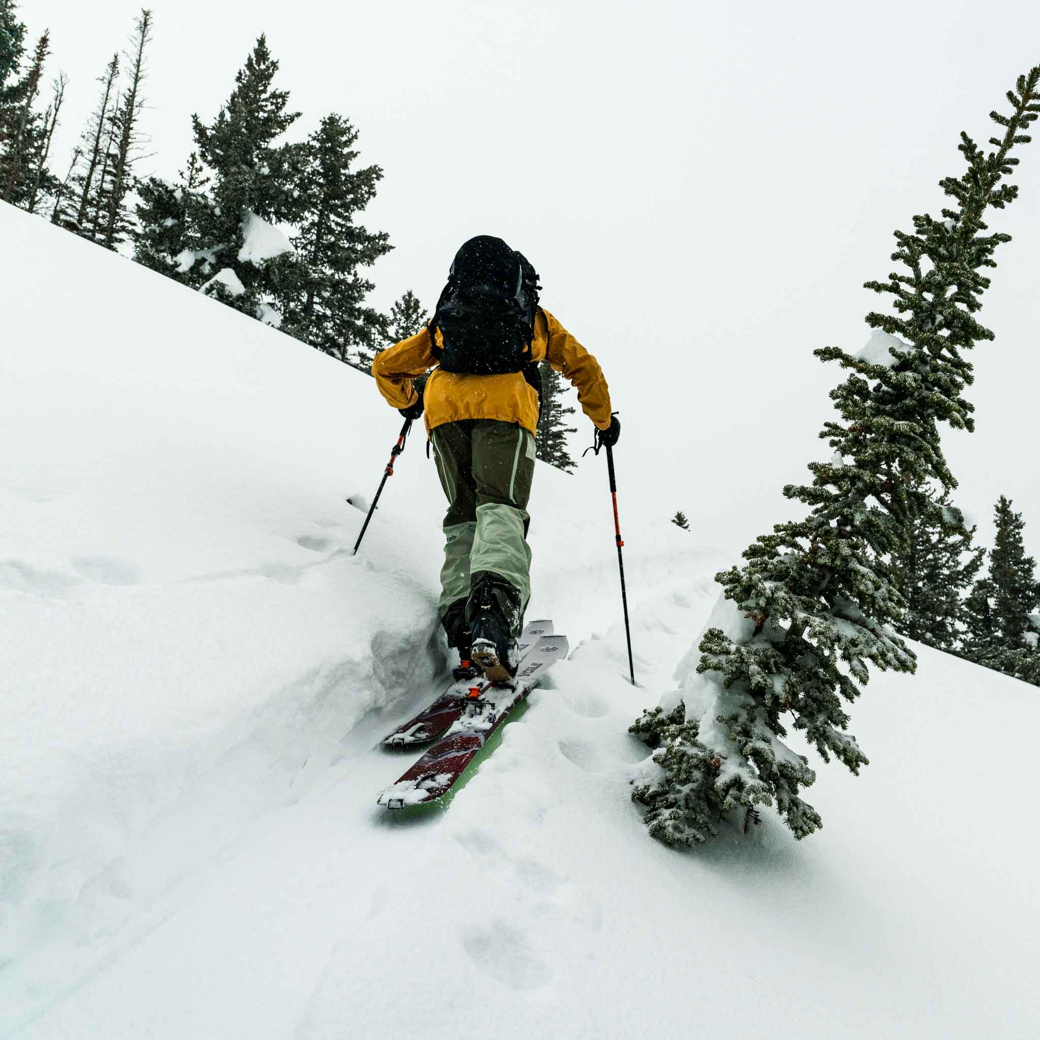 Backcountry skier climbing uphill through fresh snow with Voile Hyper Drifter skis