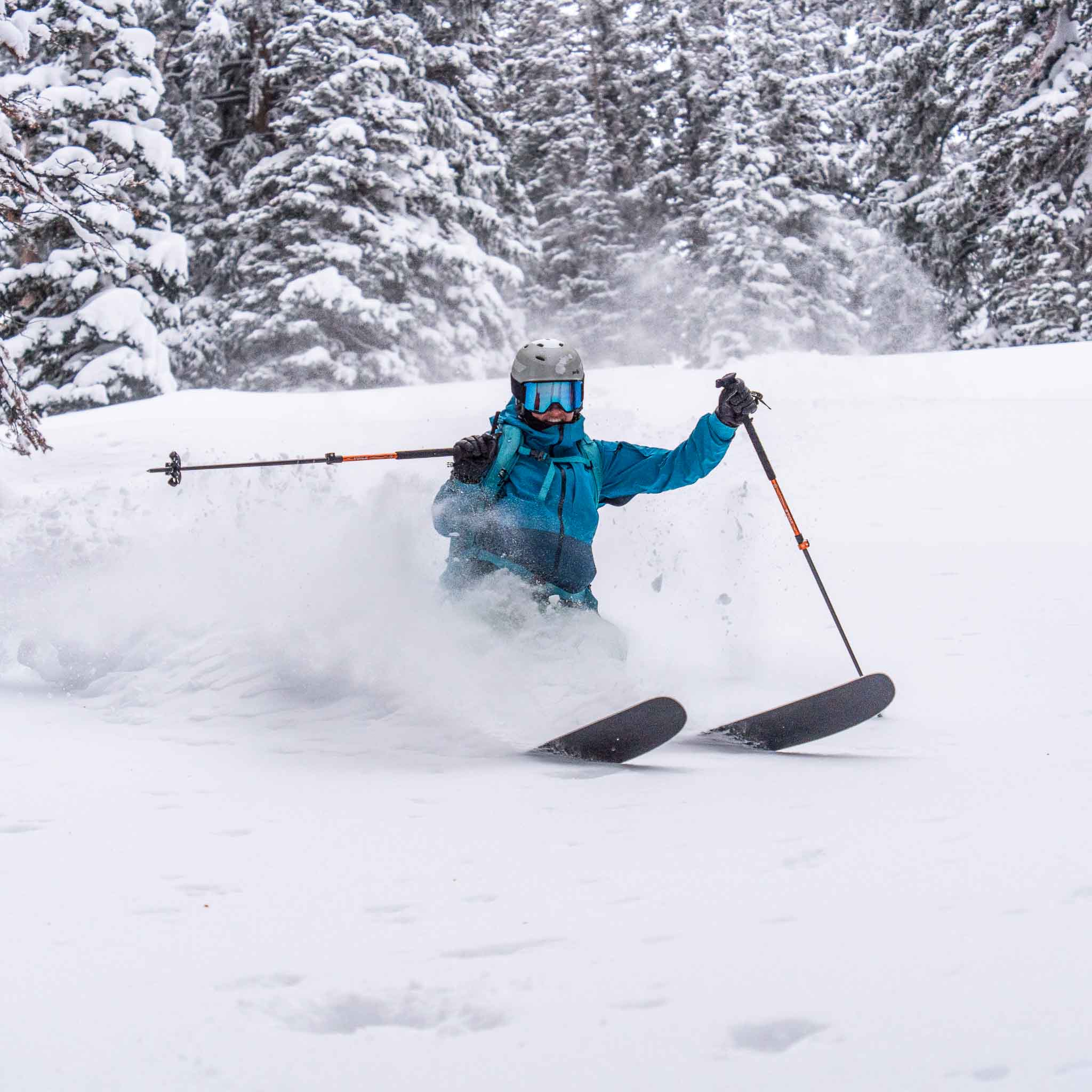 Skier dropping into terrain on Voile Hyper Drifter skis with rock outcroppings