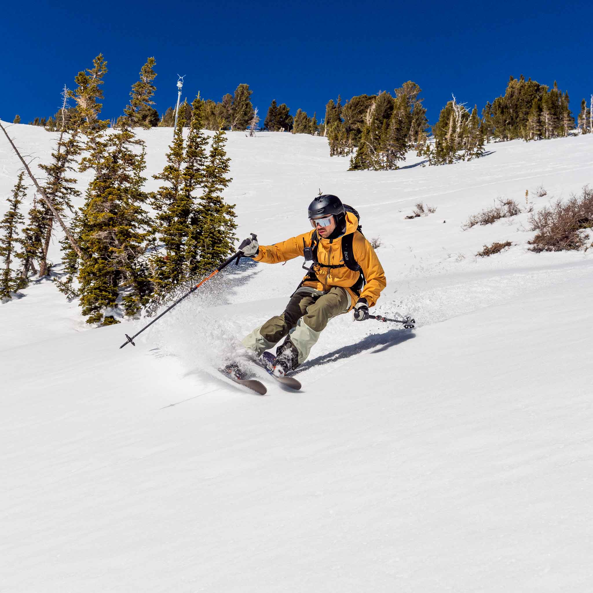Skier turning on Voile Hyper Manti skis on a sunlit snow slope